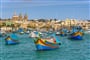 Traditional fishing boats Luzzu moored at Marsaxlokk Harbor, Malta_shutterstock_514719148