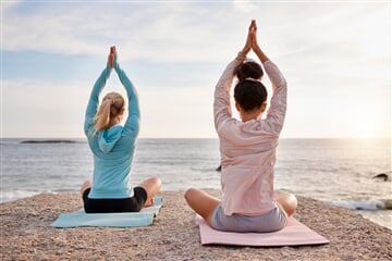 yoga back and arms raised on sunrise beach ocean 2023 11 27 05 26 15 utc