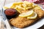 wiener-schnitzel-with-fried-potatoes-wooden-table