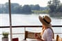woman relaxing reading a book on sundeck
